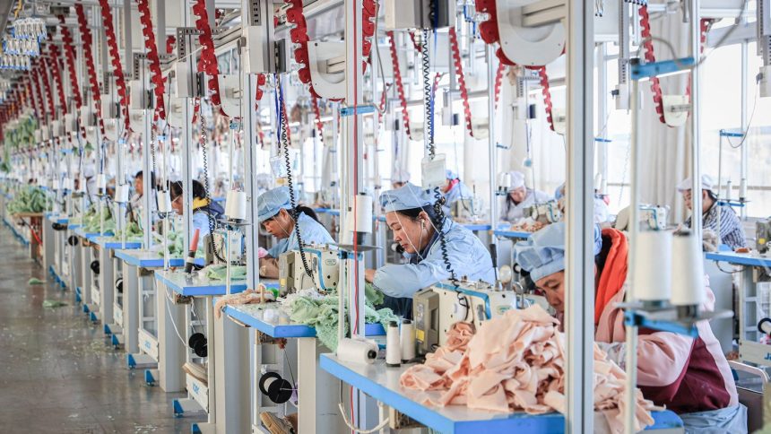 Employees work on a production line making stuffed teddy bears for export at a factory in Lianyungang, in eastern China's Jiangsu province on November 22, 2024.