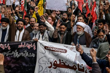 Shiite Muslims hold placards and shout slogans during a protest march against the sectarian attacks in Kurram district in Parachinar, the mountainous Khyber Pakhtunkhwa province, in Lahore on November 22, 2024. Thousands of Shiite Muslims took to the streets in various cities of Pakistan on November 22, AFP correspondents said, a day after sectarian attacks in the northwest killed 43 people, including women and children. (Photo by Arif ALI / AFP) (Photo by ARIF ALI/AFP via Getty Images)