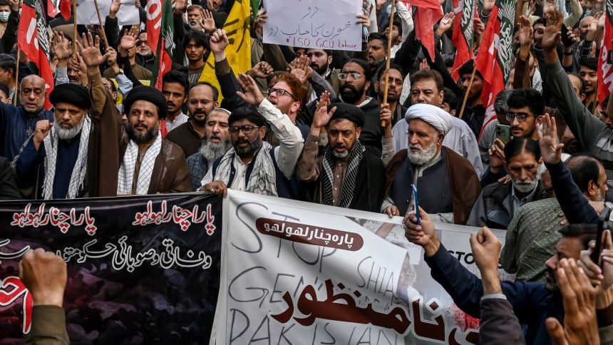 Shiite Muslims hold placards and shout slogans during a protest march against the sectarian attacks in Kurram district in Parachinar, the mountainous Khyber Pakhtunkhwa province, in Lahore on November 22, 2024. Thousands of Shiite Muslims took to the streets in various cities of Pakistan on November 22, AFP correspondents said, a day after sectarian attacks in the northwest killed 43 people, including women and children. (Photo by Arif ALI / AFP) (Photo by ARIF ALI/AFP via Getty Images)