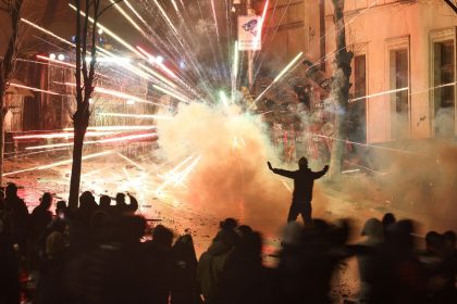 Fireworks explode as protesters clash with police outside the Georgia parliament during a demonstration in Tbilisi, early on December 1, 2024.