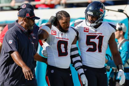 Houston Texans linebacker Azeez Al-Shaair (No. 0) was escorted off the field after being ejected from Sunday's game against the Jacksonville Jaguars.