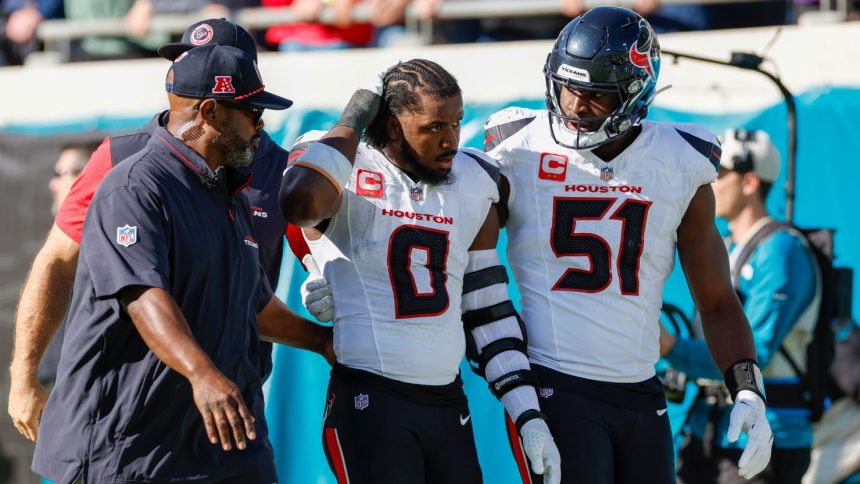 Houston Texans linebacker Azeez Al-Shaair (No. 0) was escorted off the field after being ejected from Sunday's game against the Jacksonville Jaguars.