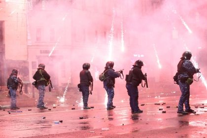 TBILISI, GEORGIA - DECEMBER 02: Protesters set garbage cans on fire and use pyrotechnics against the police while the police uses tear gas as they clash during a protest against the decision to suspend Georgia's EU accession negotiations until 2028 on December 2, 2024 in Tbilisi, Georgia. (Photo by Davit Kachkachishvili/Anadolu via Getty Images)