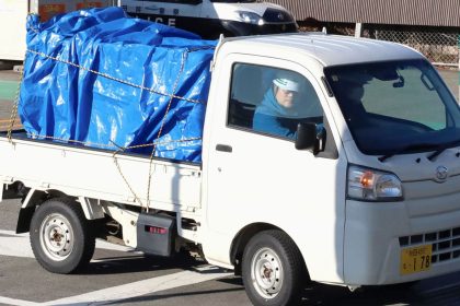 A minitruck carrying a bear which was trapped and killed after a two-day stay in a supermarket is seen leaving the facility in Akita, northeastern Japan, on Dec. 2, 2024. The animal attacked a male employee and ate from the store's meat section, according to police. (Photo by Kyodo News via Getty Images)