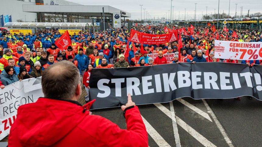 Employees of German car maker Volkswagen (VW) demonstrate in front of the VW plant in Zwickau, eastern Germany, on December 2, 2024, as thousands of Volkswagen workers go on strike all over Germany in an escalating industrial dispute at the crisis-hit German auto giant with thousands of jobs at stake. VW has been hit hard by high manufacturing costs at home, a stuttering shift to electric vehicles and tough competition in key market China. It has announced a plan to cut billions of dollars in costs.