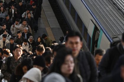 Commuters disembark from a train at a train station in Seoul on December 6, 2024.