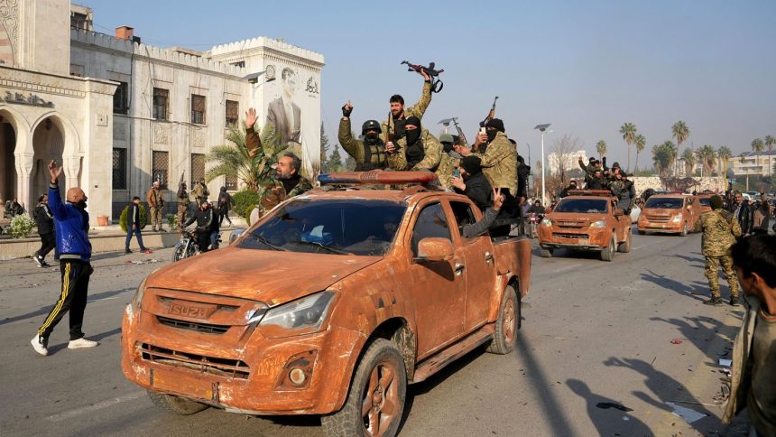 Syrian anti-government fighters celebrate as they pour into the captured central-west city of Hama on Friday.