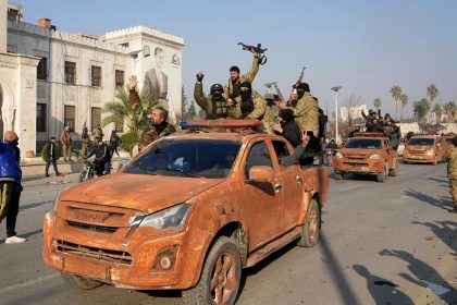 Syrian anti government fighters celebrate as they pour into the captured central-west city of Hama on December 6, 2024. In little over a week, the offensive by rebel forces has seen Syria's second city Aleppo and strategically located Hama fall from President Bashar al-Assad's control for the first time since the civil war began in 2011. (Photo by MUHAMMAD HAJ KADOUR / AFP) (Photo by MUHAMMAD HAJ KADOUR/AFP via Getty Images)