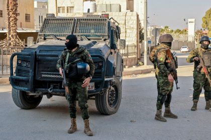 Palestinian security forces stand guard at a roadblock in Jenin following clashes with militants the day before.