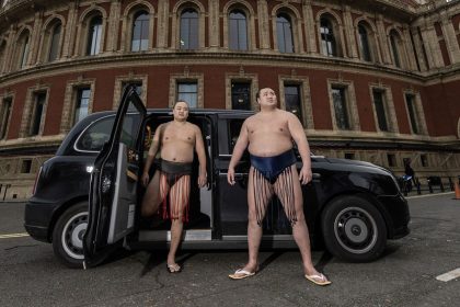 Sumo Wrestlers Kitanowaka Daisuke and Fukutsuumi Akira pose with a London Black Cab following the announcement that the elite tier of the sport will return to London for the first time in more than three decades.