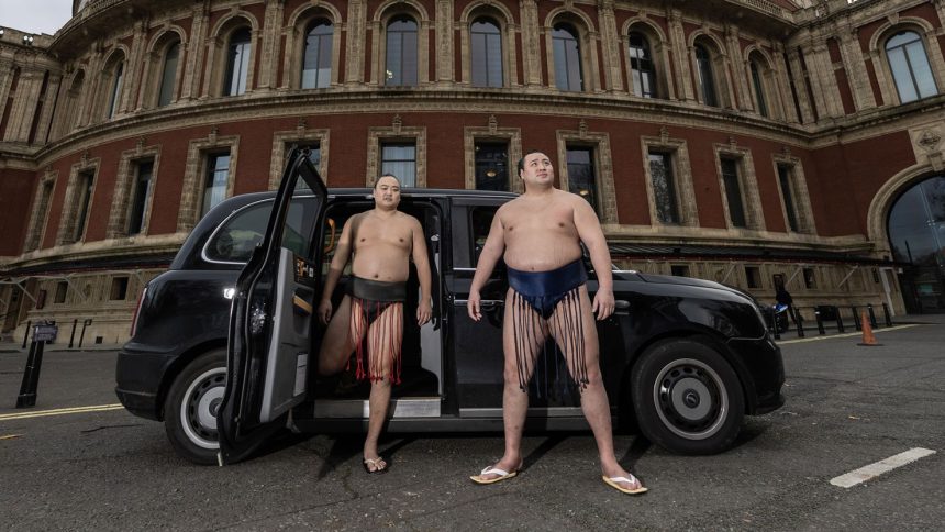 Sumo Wrestlers Kitanowaka Daisuke and Fukutsuumi Akira pose with a London Black Cab following the announcement that the elite tier of the sport will return to London for the first time in more than three decades.