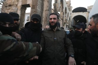 Ahmad al-Sharaa, formerly known as Abu Mohammad al-Jolani, is welcomed by supporters before addressing a crowd at the capital's landmark Umayyad Mosque on December 8.