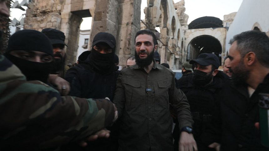 Ahmad al-Sharaa, formerly known as Abu Mohammad al-Jolani, is welcomed by supporters before addressing a crowd at the capital's landmark Umayyad Mosque on December 8.