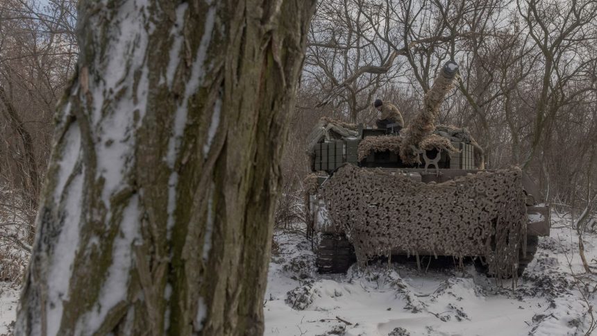 A Ukrainian crew member stands on a Leopard 1A5 tank near Pokrovsk in Ukraine's eastern Donetsk region on December 13.