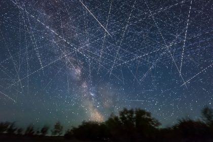 Adding together exposures taken over 30 minutes on an early June night, a composite image depicts the satellite-filled sky.