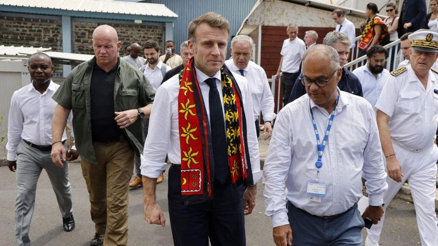 France's President Emmanuel Macron, center, visit the Mayotte Hospital Centre in Mamoudzou on December 19.