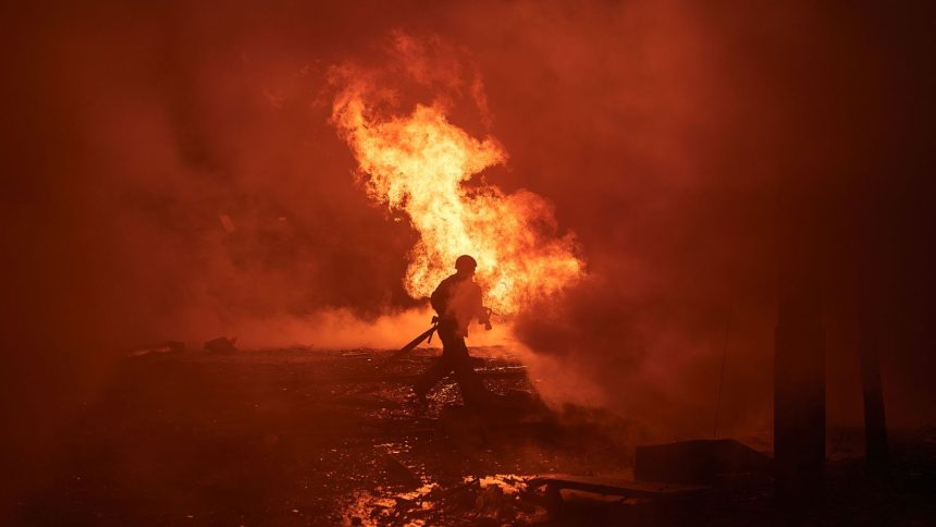 Ukrainian first responders work at the site of a Russian missile assault on the city center of Kyiv, Ukraine, on December 20, 2024.