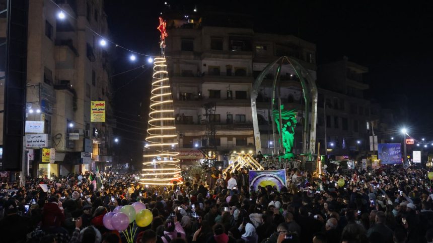 People attend a Christmas tree lighting in the Druze-majority area of Jaramana, in the Damascus countryside, on December 22, 2024.