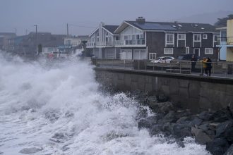 Large waves slam the Municipal Pier of Pacifica, California, on Sunday.