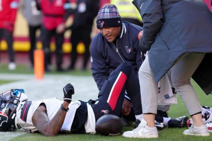 Medical staff look at Houston Texans wide receiver Tank Dell after he suffered multiple knee injuries while catching a touchdown in the third quarter of Saturday's game against the Kansas City Chiefs.