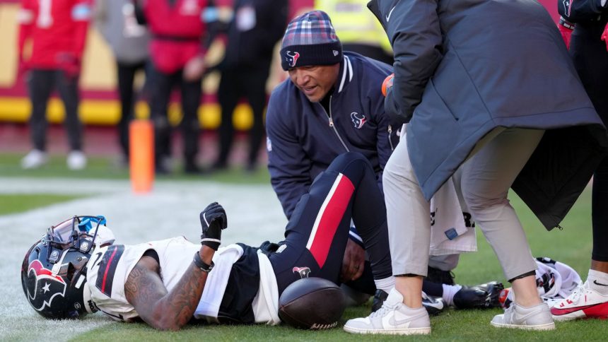 Medical staff look at Houston Texans wide receiver Tank Dell after he suffered multiple knee injuries while catching a touchdown in the third quarter of Saturday's game against the Kansas City Chiefs.