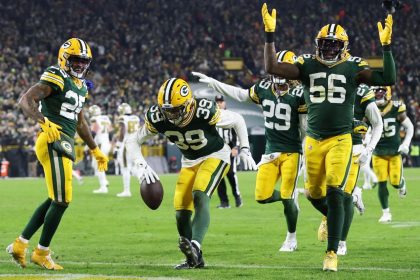 The Packers defense celebrates after an interception by Zayne Anderson.