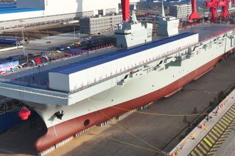 A launching ceremony is held to unveil China's first Type 076 new-generation amphibious assault ship, the Sichuan, at a shipyard in Shanghai on December 27, 2024.