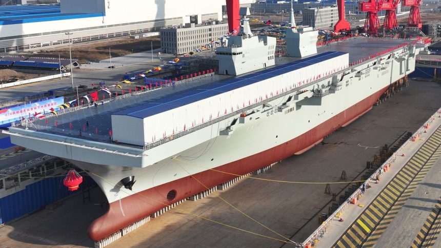 A launching ceremony is held to unveil China's first Type 076 new-generation amphibious assault ship, the Sichuan, at a shipyard in Shanghai on December 27, 2024.