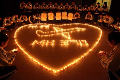 Students from an international school in east China city Zhuji light candles for the passengers onboard missing Malaysia Airlines flight MH370.