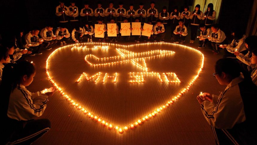 Students from an international school in east China city Zhuji light candles for the passengers onboard missing Malaysia Airlines flight MH370.