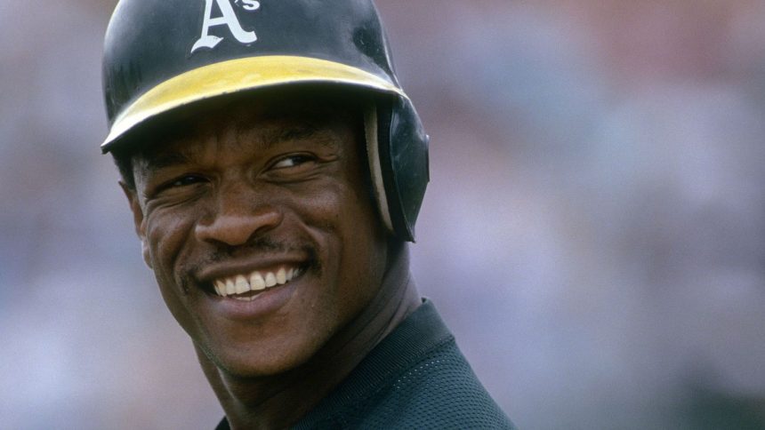 Outfielder Rickey Henderson of the Oakland Athletics on the field smiling during a game at the Oakland Coliseum in Oakland, California.