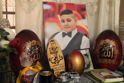 A large photograph of Rami is displayed in the Al-Halhouli family home.