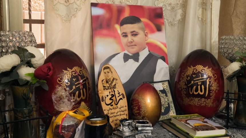 A large photograph of Rami is displayed in the Al-Halhouli family home.