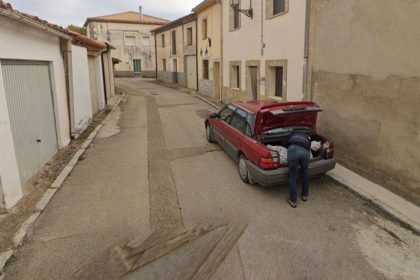 A Google Maps image showing a man leaning over the trunk of a car in Tajueco, Spain.