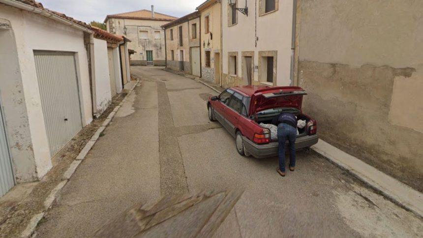 A Google Maps image showing a man leaning over the trunk of a car in Tajueco, Spain.