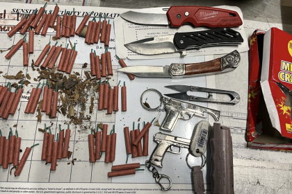 The items that were seized from the traveler's carry-on, including pepper spray and knives.