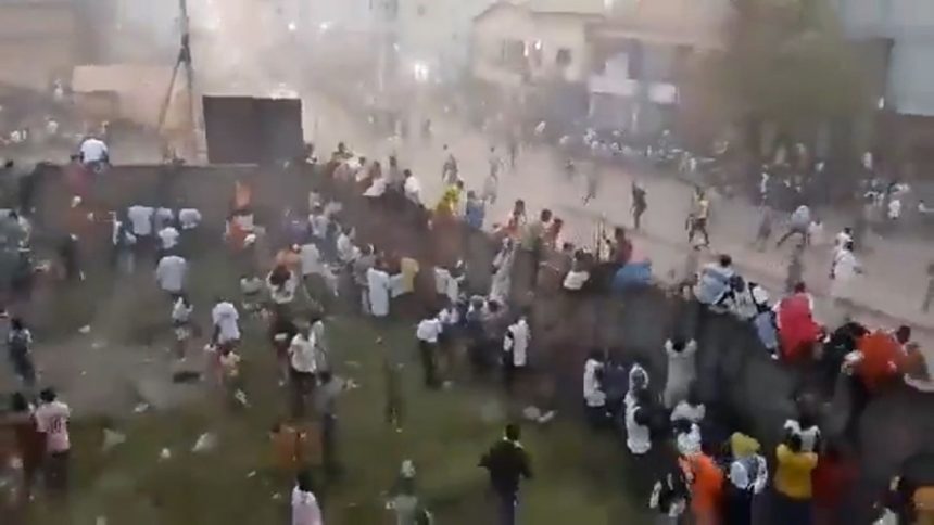 Video geolocated by CNN showed fans scaling a wall as they try to flee from the stadium in Nzérékoré in southeastern Guinea.