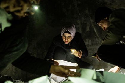 People look through documents at the Saydnaya prison in Damascus on December 11.