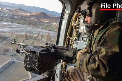 A Taliban security personnel keeps watch from a helicopter, two days after airstrikes by Pakistan in Afghanistan’s eastern Paktika province on December 26.