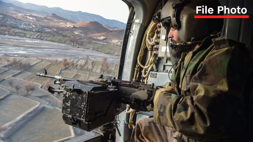 A Taliban security personnel keeps watch from a helicopter, two days after airstrikes by Pakistan in Afghanistan’s eastern Paktika province on December 26.