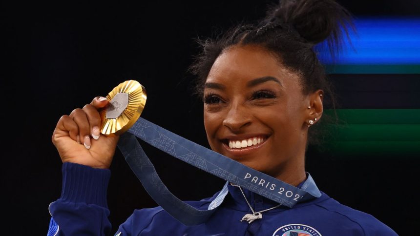 Simone Biles celebrates winning gold at the Paris Games in 2024.