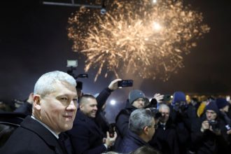 Romanian minister of Internal Affairs Catalin Predoiu amid fireworks as Romania and Bulgaria join the EU's Schengen area.