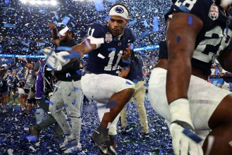 Nittany Lions defensive end Abdul Carter (No. 11) celebrates with his teammates after winning the Fiesta Bowl.