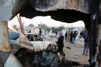 Palestinians survey the aftermath of an Israeli strike in Al-Mawasi, southern Gaza, on January 2.