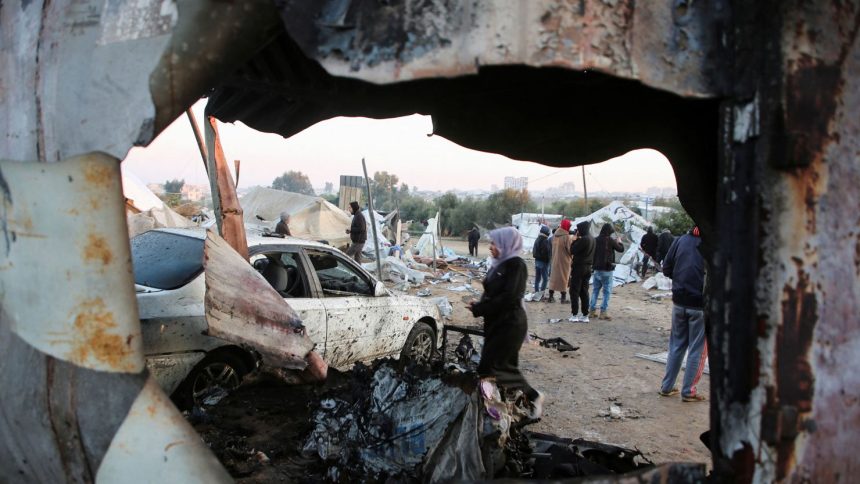 Palestinians survey the aftermath of an Israeli strike in Al-Mawasi, southern Gaza, on January 2.