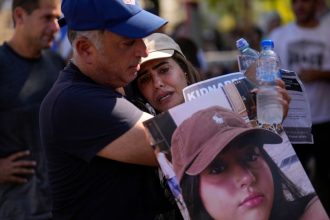 Eli, left, and Shira, parents of Liri Albag, hold her photograph at a protest demanding the release of the hostages in Tel Aviv, Israel, in October 2023.