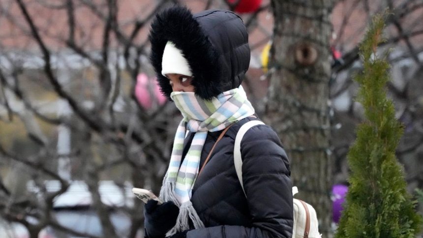 A pedestrian bundles up during cold weather in Skokie, Illinois, on December 12, 2024.