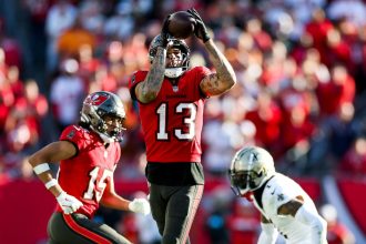 Tampa Bay Buccaneers wide receiver Mike Evans catches a pass during an NFL football game against the New Orleans Saints on Sunday, January 5, in Tampa, Florida. With this catch, Evans surpasses 1,000 receiving yards for the 11th straight season.