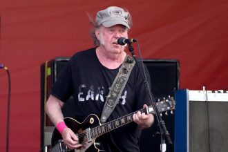 Neil Young performing at the 2024 New Orleans Jazz & Heritage Festival.