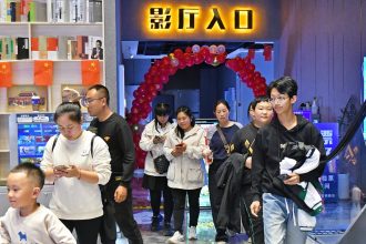 People walk inside a cinema in the Fushan district of Yantai city, Shandong province, on October 7, 2024.